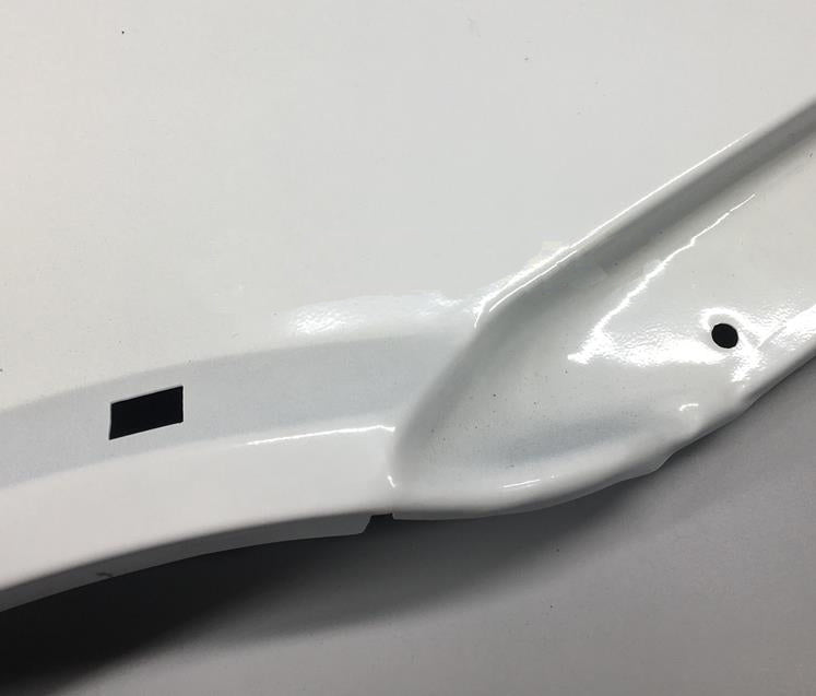 White front fender outer panel close-up with curved lip and mounting holes