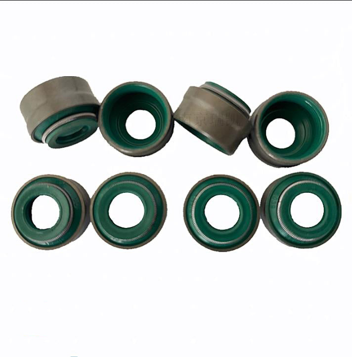 Valve oil seal set with green rubber seal lips and metal sleeves, multiple views