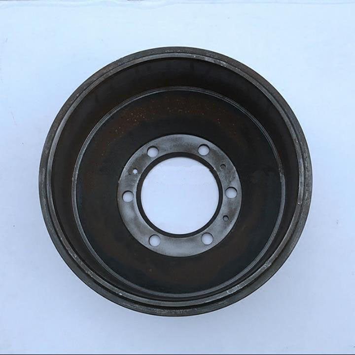 Brake drum with dark outer surface and circular mounting flange with bolt holes