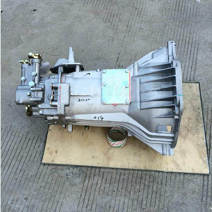 Silver metal transmission gearbox case with attached gear assembly and mounting holes