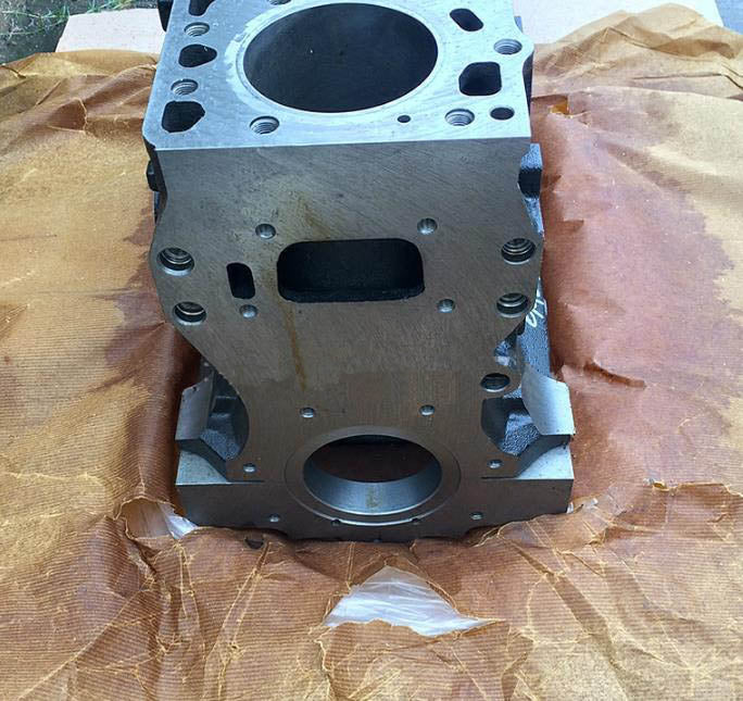 Engine cylinder block side view with gasket surfaces and mounting holes, silver