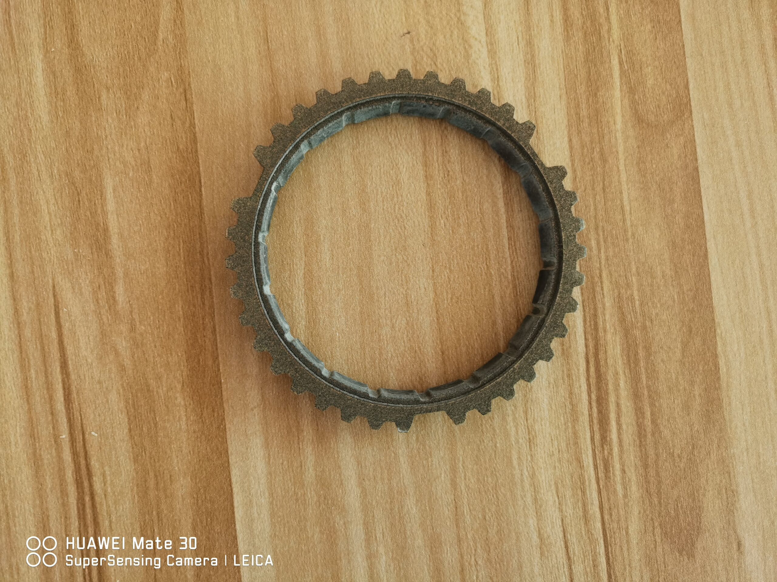 Synchronizer ring gear laid flat, showing outer teeth and inner ring