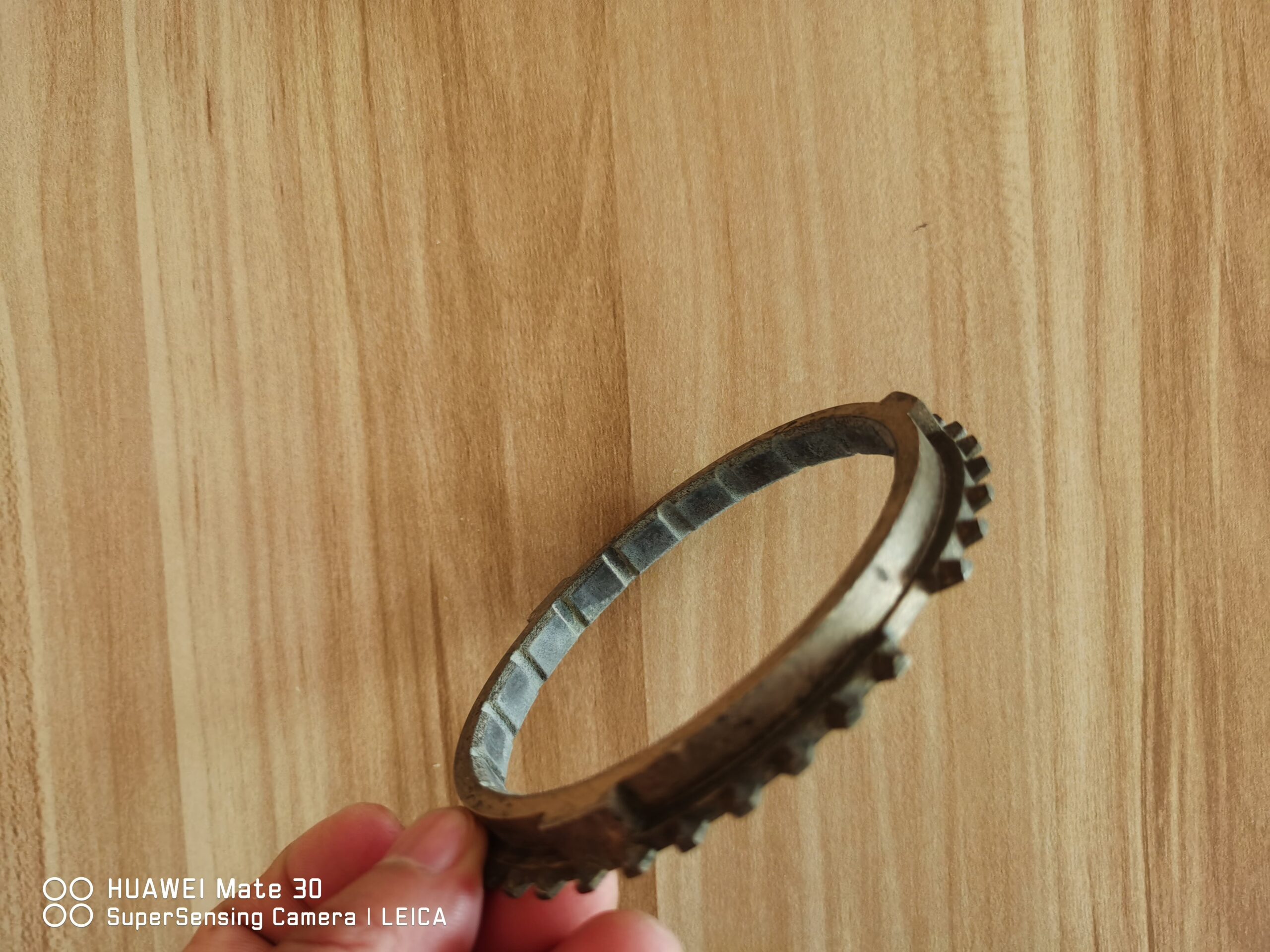 Synchronizer ring gear, side view showing toothed outer rim and inner ring