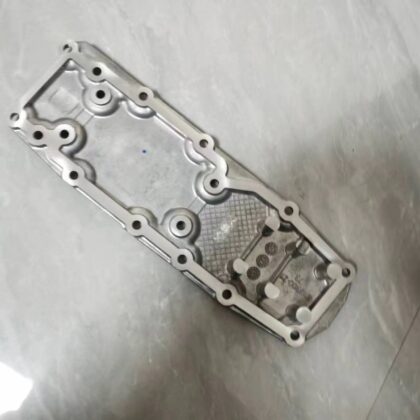 Metallic silver gearbox gear shift cover plate with bolt holes and internal cutout