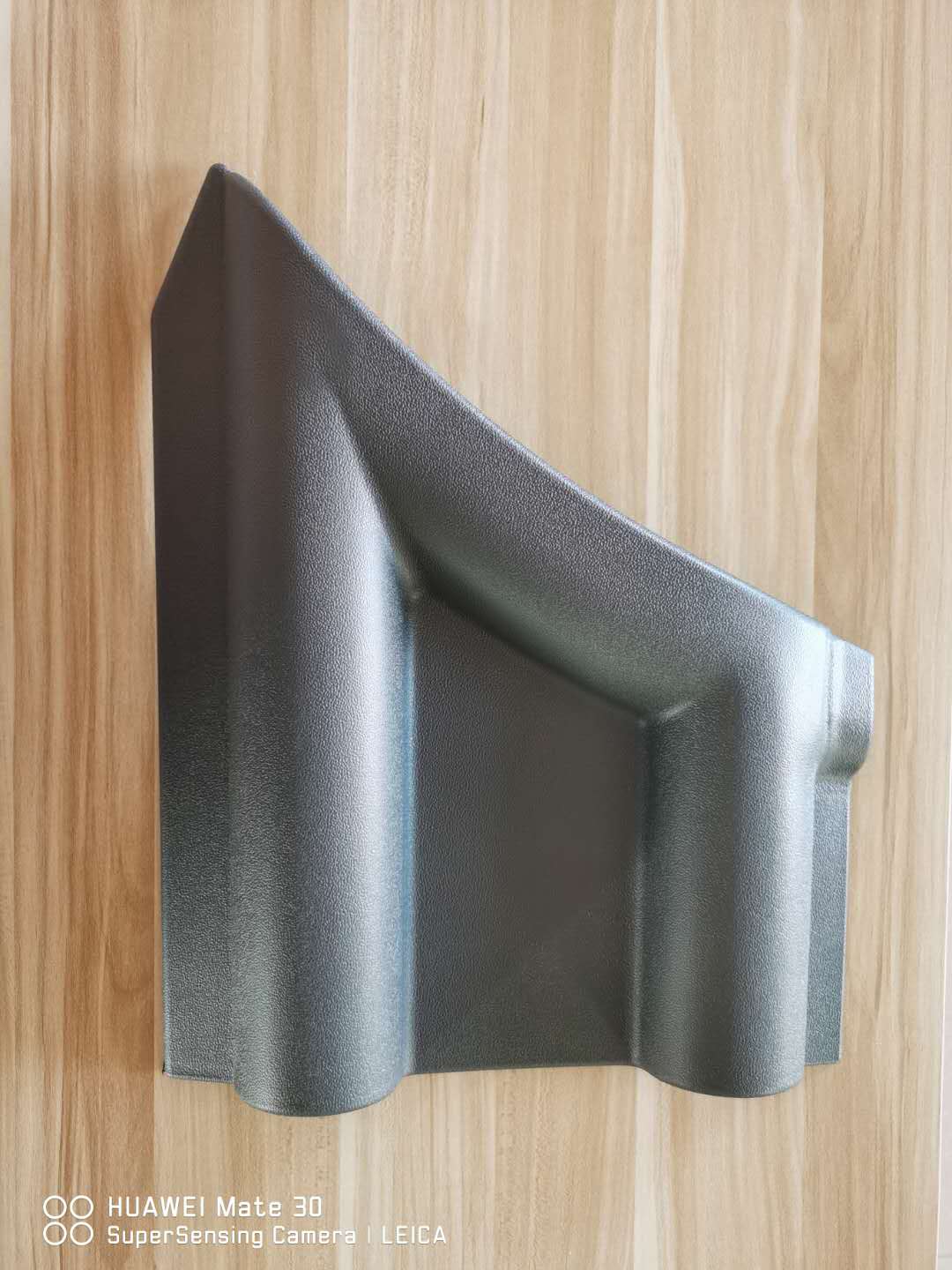 Front bumper plastic sheet, dark gray textured panel with curved edges