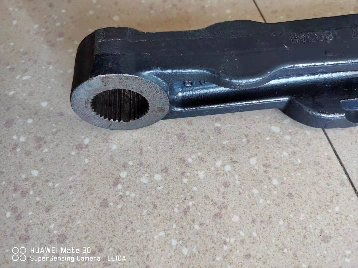Swing arm end with bushing opening and metal pin hole, black steel bracket