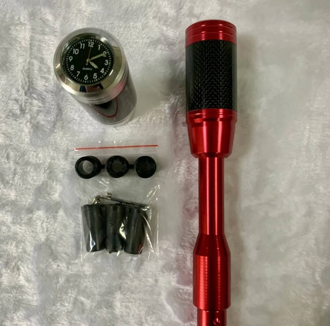 Red shift knob lengthener with clock gauge, carbon-fiber grip, and rubber mounting caps