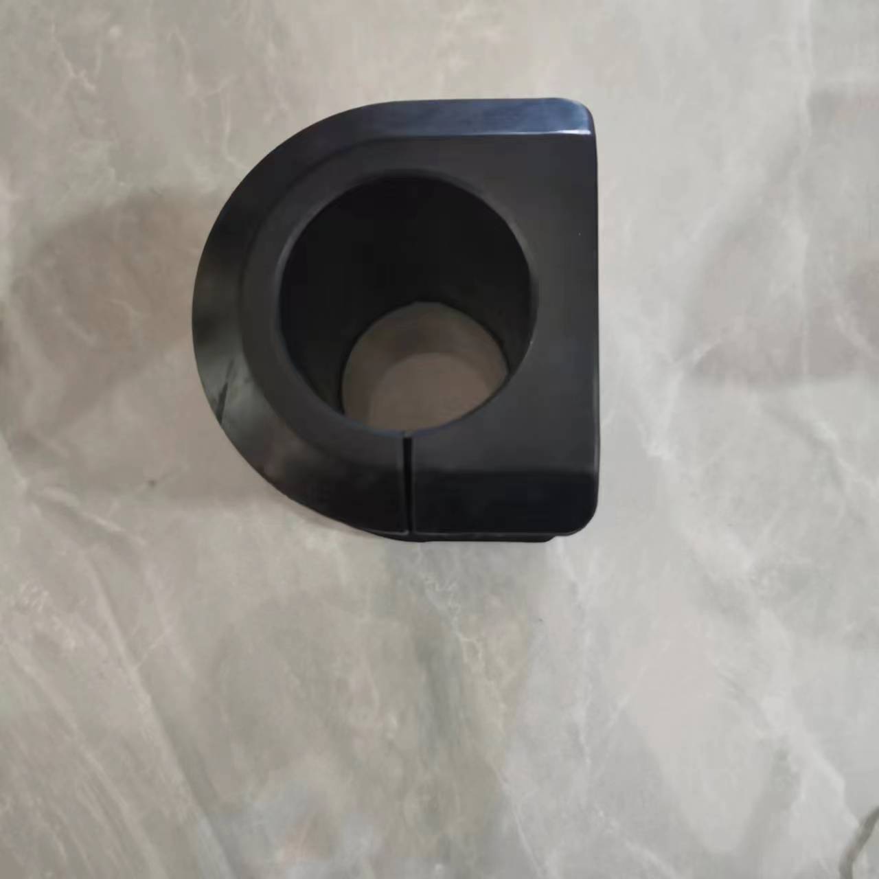 Black stabilizer bar bushing with semicircle body and inner opening