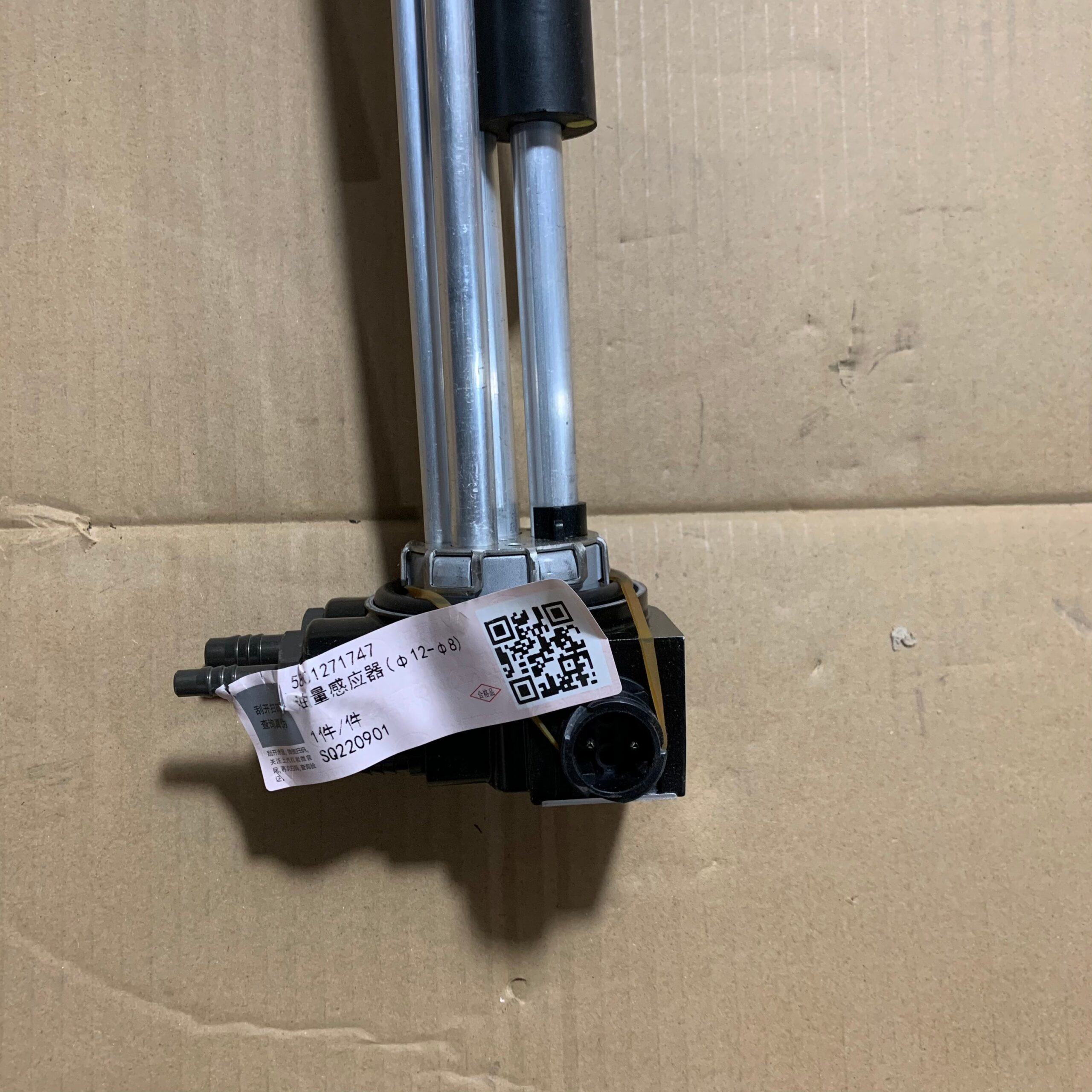 Fuel tank float sensor unit with black electrical connector and barcode label