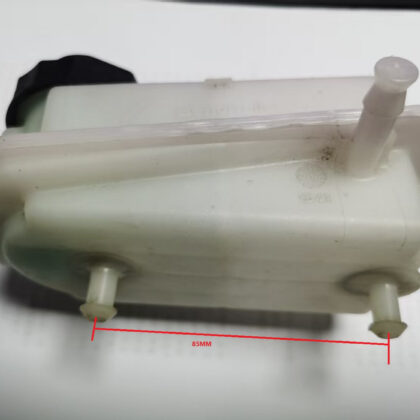 Brake fluid reservoir tank with outlet ports and side mounting fittings