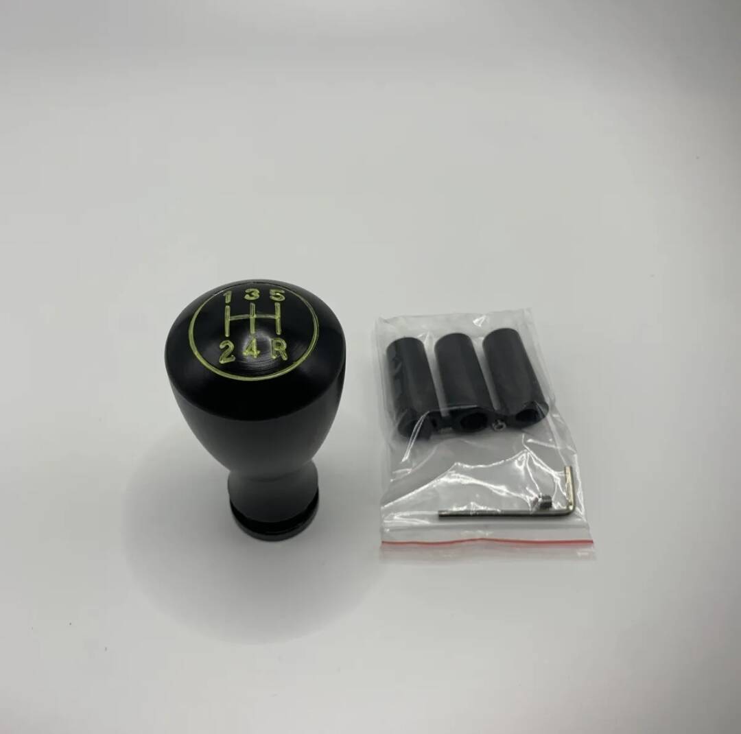 5-speed black shift knob with numbered gears, plus installation hardware in bag