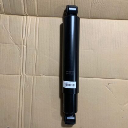 Front shock absorber, black cylinder with mounting ends and label barcode