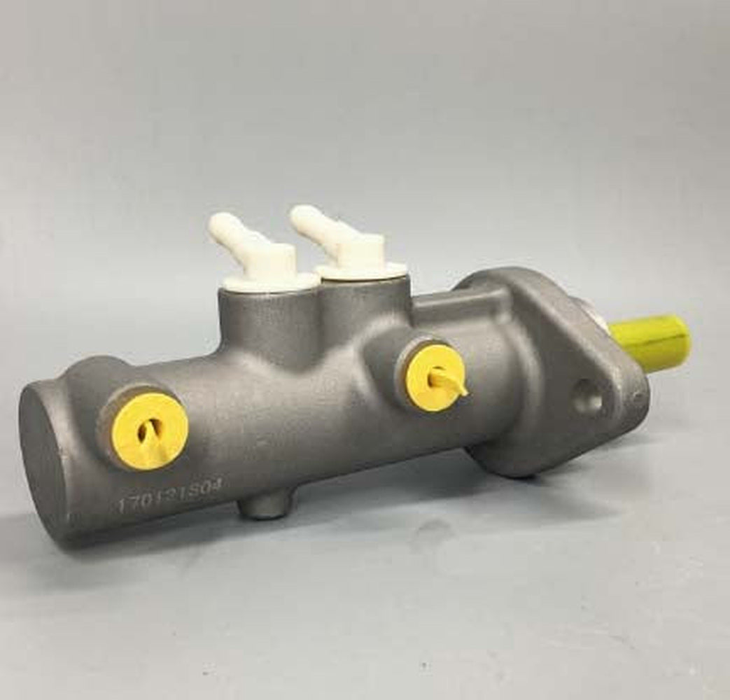 Brake master cylinder with yellow caps, two white fluid fittings, and mounting ports