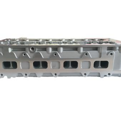 Silver cylinder head with intake ports and machined valve openings on the side by SUONAMA