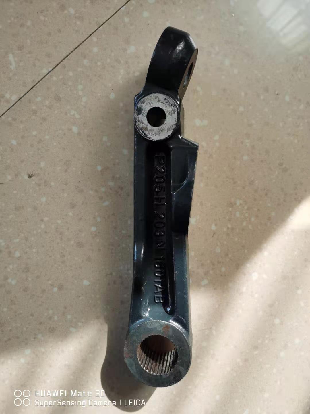 Swing arm end with mounting fork and bushing bore, blue-black steel bracket