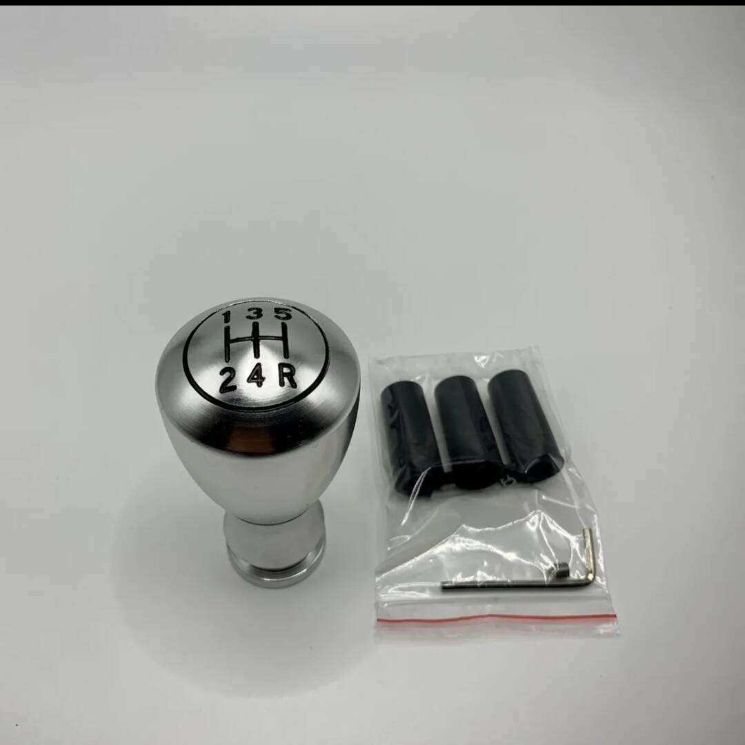 5-speed silver shift knob with gear numbers, plus installation hardware in bag
