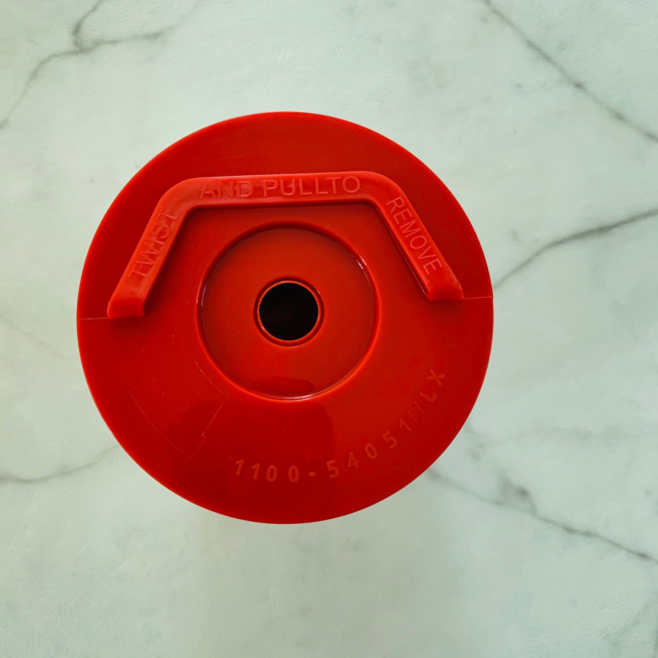 Oil water separator cap plate, red plastic, with central mounting hole