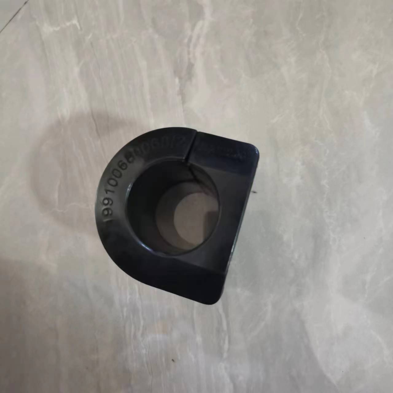 Square black stabilizer bar bushing with round center hole