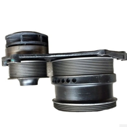 Water pump with black metal housing and threaded ports, close-up